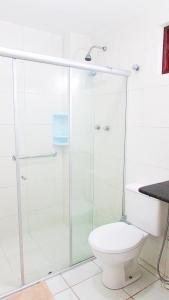 a bathroom with a glass shower with a toilet at Pousada Paraíso Francês in Praia do Frances