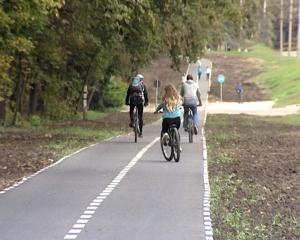 a group of people riding bikes down a road at Lux Apartament Dacha in Kharkiv