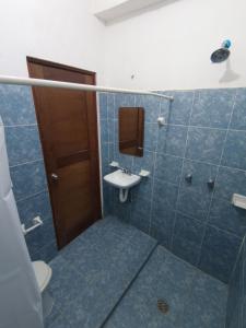 a bathroom with a sink and a toilet at Posada Antonia Bacalar in Bacalar