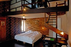 a bedroom with a loft bed and a staircase at Hostellerie La Maison de Maître in Arbrefontaine