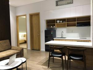 a kitchen and living room with a couch and a table at Khe Suites Le Lai Apartment - Self Check-in with Lockbox in Da Nang
