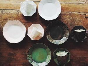 a wooden table with different types of plates on it at CHULAX OKINAWA YOMITAN【Designer Condominium Hotel】 in Yomitan