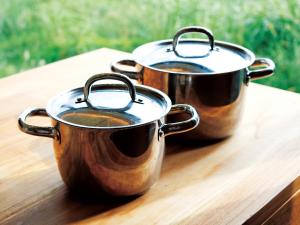 two copper pots sitting on a wooden table at CHULAX OKINAWA YOMITAN【Designer Condominium Hotel】 in Yomitan