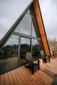 two chairs sitting on the deck of a house at Hilltop Batumi in Batumi