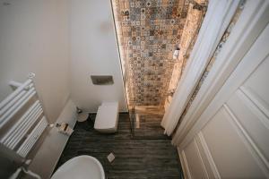 a small bathroom with a toilet and a shower at Hilltop Batumi in Batumi
