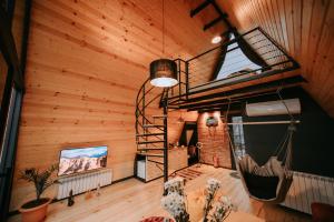 an attic room with a spiral staircase in a house at Hilltop Batumi in Batumi