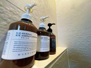 three bottles of hempel amino covenantene on a shelf at CHULAX OKINAWA YOMITAN【Designer Condominium Hotel】 in Yomitan