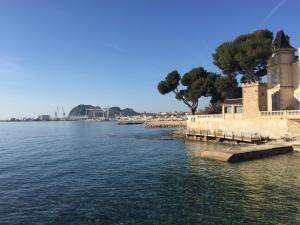 a view of a body of water with a building at Duplex La Ciotat - superbe 85 m2 - 6 pers - 3 chambres - Climatisation - Vue mer et proche du vieux port La Ciotat in La Ciotat
