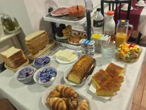 a table filled with different types of bread and pastries at Quintana 23 in Suances +19 photos
