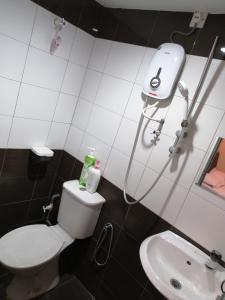 a bathroom with a toilet and a sink at StarVilla Kinta River Front Medan Istana in Ipoh