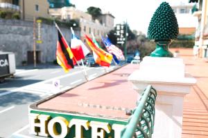 a row of international flags on a street at Rex Hotel Residence in Genoa