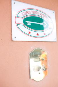 a sign on a wall with a gas meter at Rex Hotel Residence in Genoa