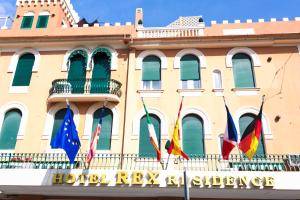 a building with flags in front of it at Rex Hotel Residence in Genoa