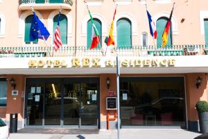a row of flags on the front of a building at Rex Hotel Residence in Genoa