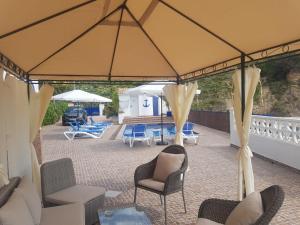 a large tent with chairs and umbrellas on a patio at A867 - La Rodeta in Callosa de Ensarriá