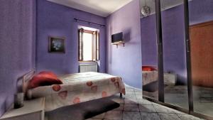 Postel nebo postele na pokoji v ubytování La Casa Colorata