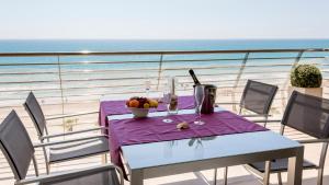 a table with a bowl of fruit on a balcony at Playa Norte 7ºG in Peniscola