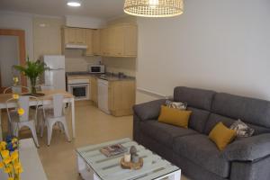 a living room with a couch and a table at La Caparina, apartamento con piscina a 3 km de la playa in Llanes