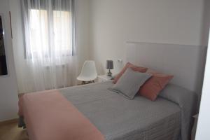a bedroom with a bed and a window at La Caparina, apartamento con piscina a 3 km de la playa VUT-2377-AS in Llanes