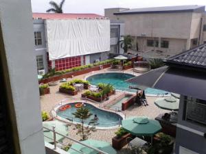 an overhead view of a swimming pool in a building at Room in Lodge - All Seasons Hotel-apartment in Owerri