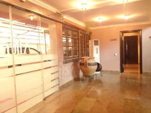 a room with wooden cabinets and a large bowl at Allure Suites - Luxury Room in Surulere +29 photos