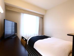 a bedroom with a large bed and a large window at APA Hotel Shintomicho-Ekimae in Tokyo
