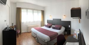 מיטה או מיטות בחדר ב-Cit'Hotel Atlantis