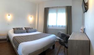 מיטה או מיטות בחדר ב-Cit'Hotel Atlantis