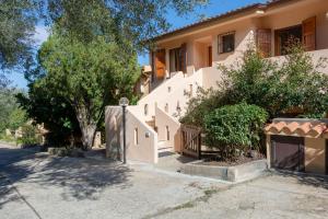 a building with stairs and trees in front of it at Sunrise Sisters' Home in Cala Gonone