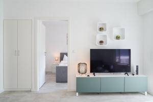a living room with a flat screen tv on a cabinet at ApartWehr Business&Ferien Apartment Türkis in Wehr