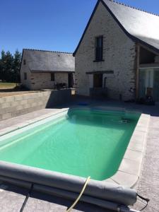 a large swimming pool in front of a house at LE GRAND PARADIS in Daumeray