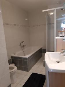 a bathroom with a tub and a toilet and a sink at Romsicht in Siegerswoude +14 photos