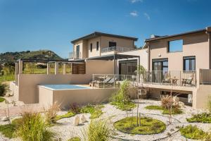 a house with a swimming pool in front of it at Ionian Village in Lixouri