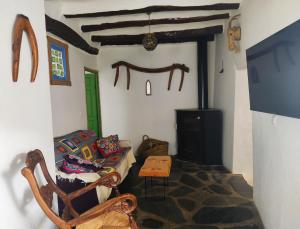 a living room with a couch and a chair and a fireplace at La Maestra in Trevélez