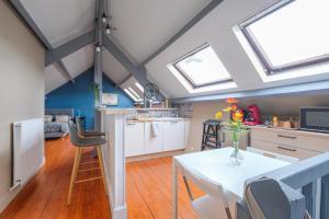 a kitchen and dining room with skylights and a table at L'escale Nemourienne in Nemours