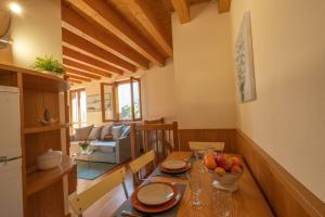 a kitchen with a wooden table with a bowl of fruit on it at Happy Guest Apartments - Feel The Lake in Riva di Solto