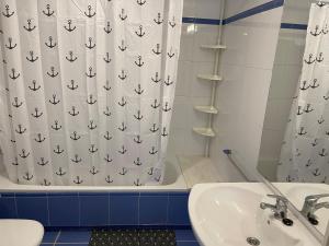 a bathroom with a sink and a shower curtain at SeaHomes Vacations, FENALS BEACH&CHIC, pk, top apartment full equipped in Lloret de Mar