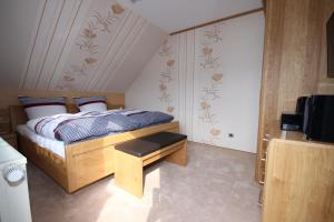 a bedroom with a bed and a television in it at Ferienhaus Marienweg in Hallenberg
