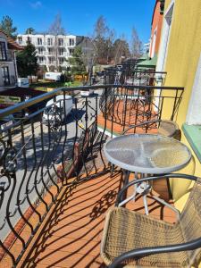 a patio with a table and chairs on a balcony at Willa u Anny in Mielno +6 photos
