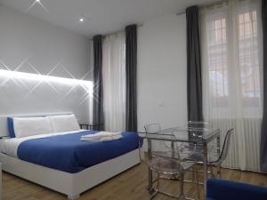 a bedroom with a bed and a glass table at Giudei House Loft 2 in Bologna