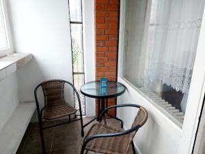 a small table and two chairs on a balcony at Red brick in Belgrade
