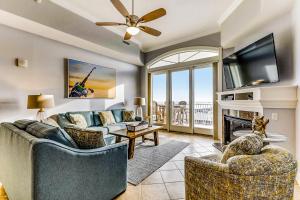 a living room with a couch and a tv and a fireplace at South Beach in Ocean City