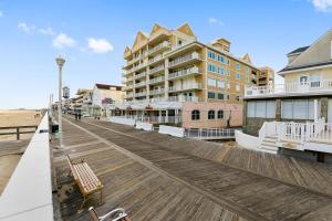 a boardwalk on a beach with a building at South Beach in Ocean City