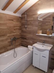 a bathroom with a white tub and a sink at Mountain village in Žabljak +27 photos