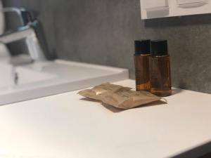 two bottles ofodorizers sitting on a counter in a bathroom at Plażowa Residence in Szczyrk