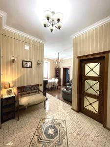 a living room with a door leading to a dining room at Apartment on Franka in Lviv