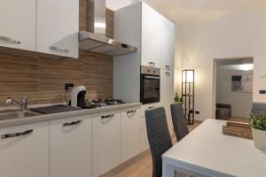 a kitchen with white cabinets and a counter top at Residenza San Leonardo - Viterbo Centro Storico in Viterbo