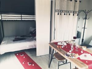 a bedroom with a table and a bunk bed at Chalet du bien-être in Hornaing