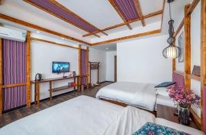 Krevet ili kreveti u jedinici u okviru objekta Zhangjiajie Highlights Guesthouse