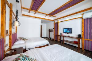 Krevet ili kreveti u jedinici u okviru objekta Zhangjiajie Highlights Guesthouse